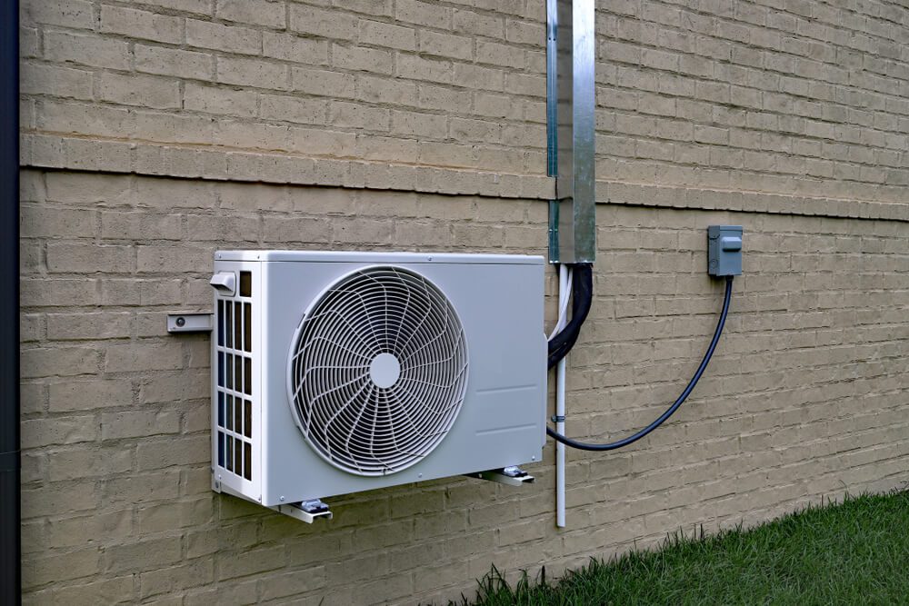 Air Conditioner mini split  compressor system mounted on brick outdoors